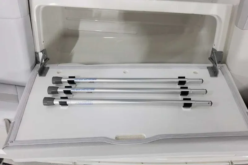 Slide: The Image of Storage compartment with metal rods in a 2027 Formula 360 Crossover Bowrider OB. - 48