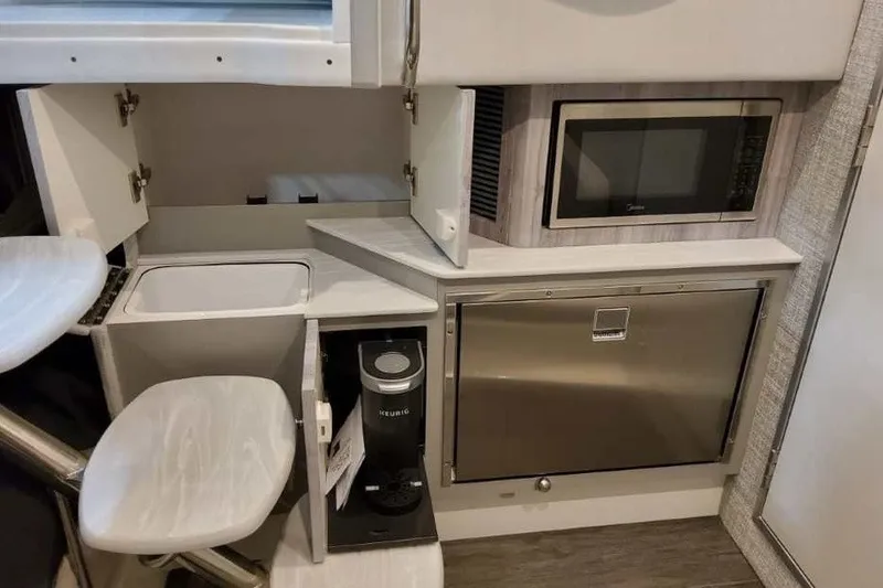 Slide: The Image of Compact kitchenette in 2027 Formula 360 Crossover Bowrider OB with microwave and storage. - 70