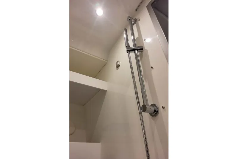 Slide: The Image of Shower area in 2027 Formula 360 Crossover Bowrider OB boat, featuring chrome fixtures. - 76