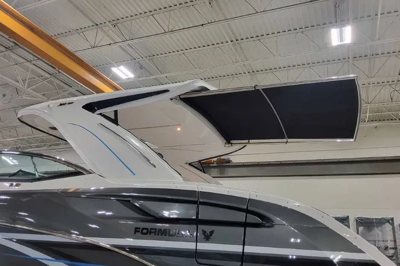 Slide: The Image of 2027 Formula 360 Crossover Bowrider OB with extended canopy in a showroom. - 58