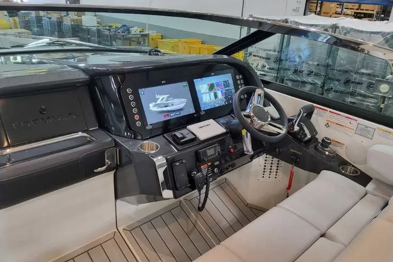 Slide: The Image of 2027 Formula 360 Crossover Bowrider OB helm with modern controls and dual display screens. - 37
