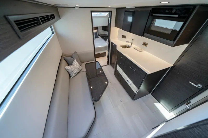 Slide: The Image of 2026 Valhalla V-55 Sport Yacht interior with modern kitchen and seating area. - 6
