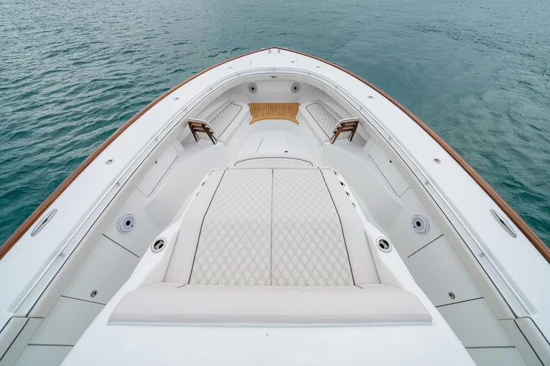 Slide: The Image of 2026 Valhalla Boatworks V-55 bow view, featuring luxurious seating and teak accents on calm water. - 3