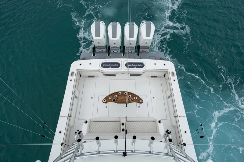 Slide: The Image of 2026 Valhalla V-55 boat with four engines cruising on blue water. - 14