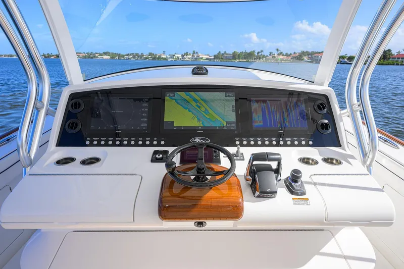Slide: The Image of 2026 Valhalla Boatworks V-46 helm with advanced navigation displays and controls on open water. - 6
