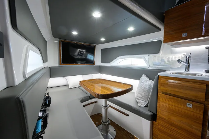 Slide: The Image of Luxurious interior of 2026 Valhalla Boatworks V-46 with modern seating and kitchenette. - 13