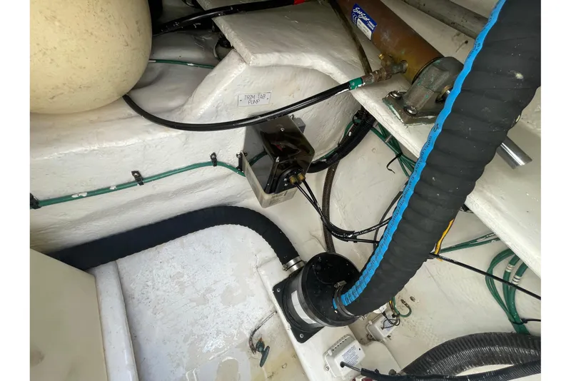 Slide: The Image of Engine compartment of a 2007 Luhrs 31 Open boat, showing trim tab pump and wiring. - 17