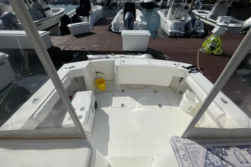 Slide: The Image of 2007 Luhrs 31 Open boat interior at marina, featuring seating and storage. - 4