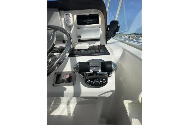 Slide: The Image of 2007 Luhrs 31 Open boat helm with steering wheel and control panel. - 9