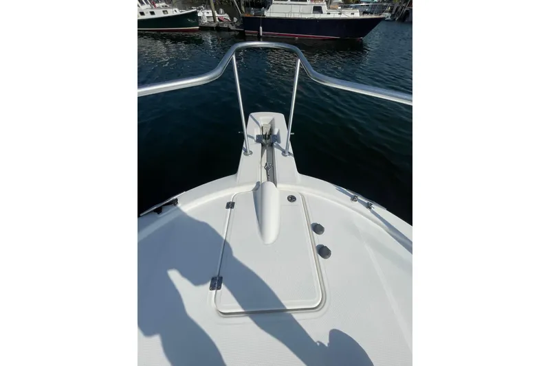 Slide: The Image of Bow view of 2007 Luhrs 31 Open boat, featuring anchor and railing, docked in marina. - 8