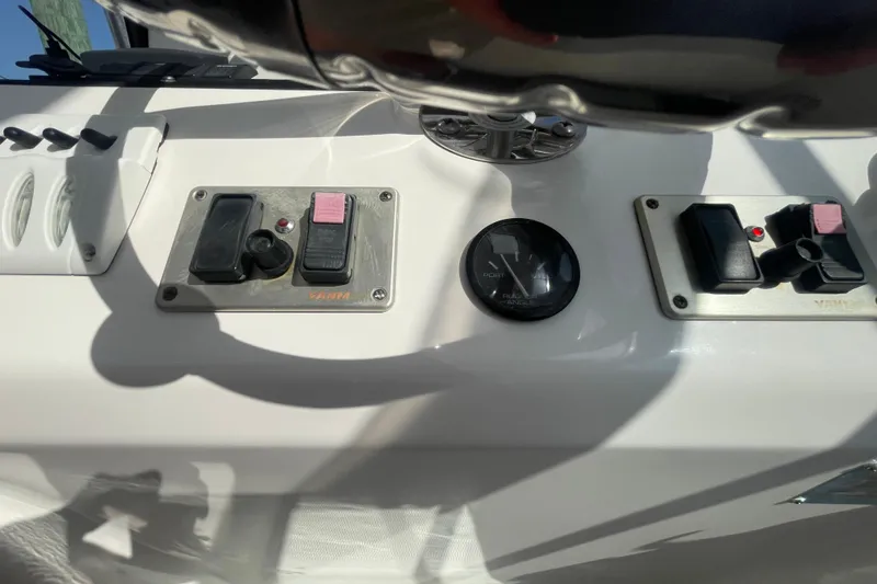 Slide: The Image of Control panel of a 2007 Luhrs 31 Open boat with switches and gauge. - 13