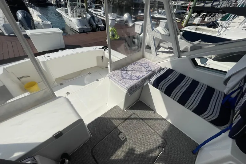 Slide: The Image of 2007 Luhrs 31 Open boat interior with striped seating and marina view. - 5