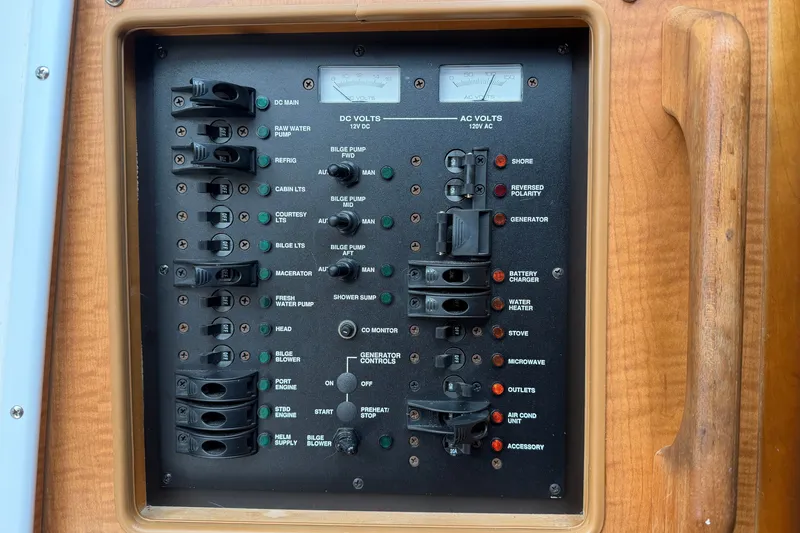 Slide: The Image of Electrical control panel on a 2007 Luhrs 31 Open boat, featuring various switches and gauges. - 23