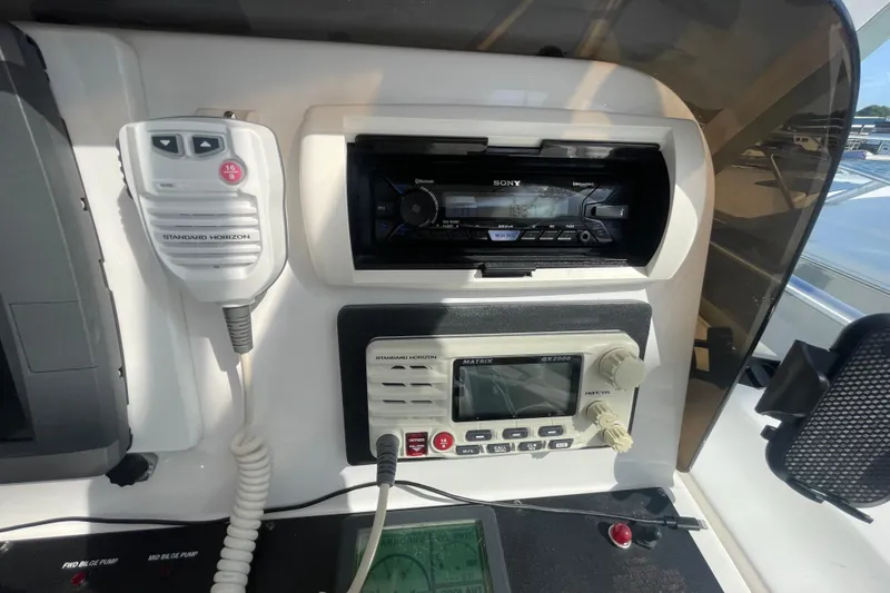 Slide: The Image of Control panel of a 2007 Luhrs 31 Open boat featuring communication and audio equipment. - 10
