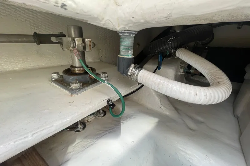Slide: The Image of Engine compartment of a 2007 Luhrs 31 Open boat, showing mechanical components and hoses. - 20