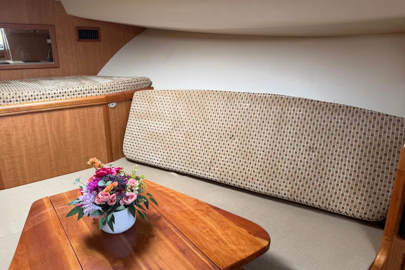 Slide: The Image of Interior of 2007 Luhrs 31 Open boat with wooden table and floral centerpiece. - 18