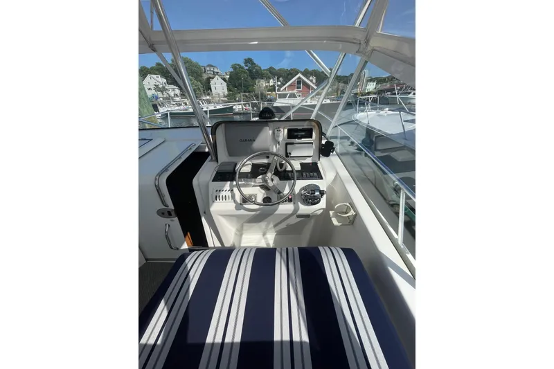 Slide: The Image of Helm of 2007 Luhrs 31 Open boat with striped seating and Garmin navigation system. - 6