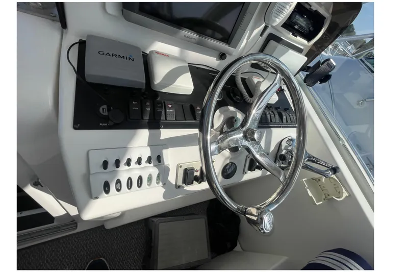 Slide: The Image of 2007 Luhrs 31 Open helm with Garmin navigation and chrome steering wheel. - 7