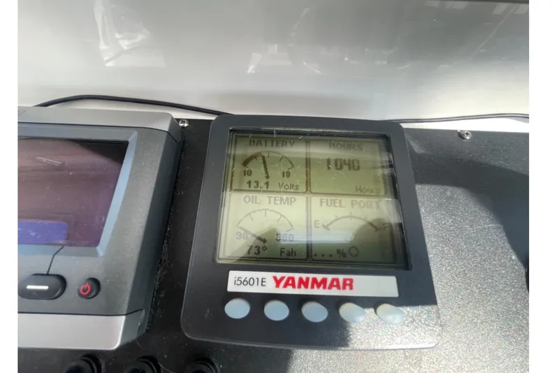 Slide: The Image of Yanmar engine display on a 2007 Luhrs 31 Open boat, showing battery voltage and engine hours. - 12