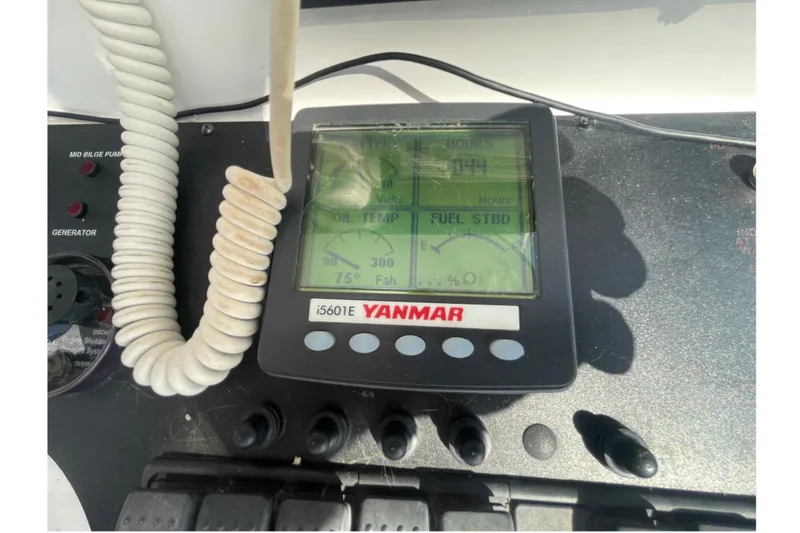 Slide: The Image of Yanmar engine display on 2007 Luhrs 31 Open boat dashboard, showing oil temperature and fuel status. - 11