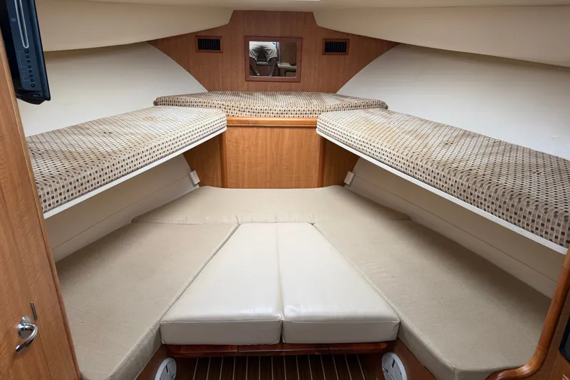 Slide: The Image of 2007 Luhrs 31 Open cabin interior with twin berths and wood paneling. - 16