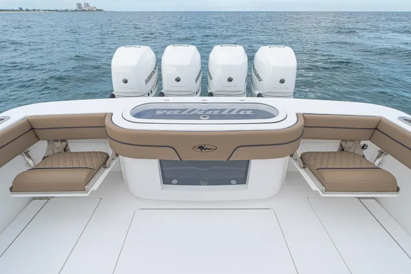Slide: The Image of 2026 Valhalla Boatworks V-41 with quad Mercury engines, featuring luxurious seating and ocean backdrop. - 16