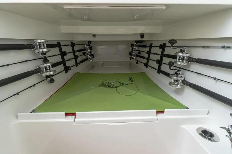 Slide: The Image of Interior of 2026 Valhalla Boatworks V-41, featuring organized fishing rod storage. - 12