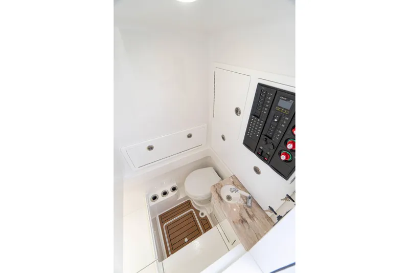 Slide: The Image of 2027 Valhalla Boatworks V-33 interior with control panel and compact bathroom. - 21