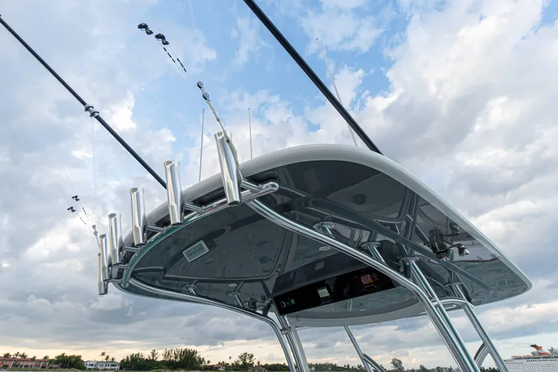 Slide: The Image of 2027 Valhalla Boatworks V-33 with fishing rods against a cloudy sky backdrop. - 13