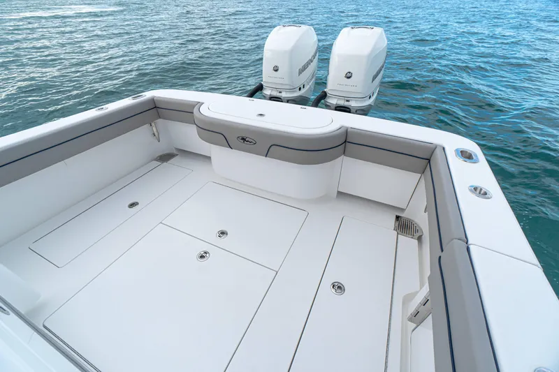 Slide: The Image of 2027 Valhalla Boatworks V-33 deck with twin engines on calm water. - 14