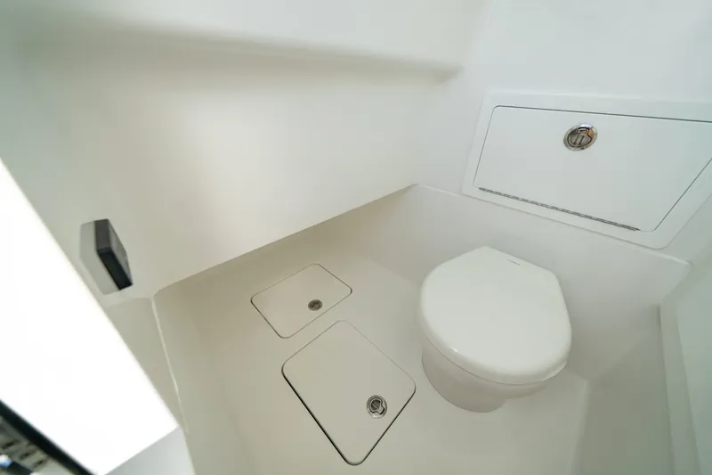 Slide: The Image of 2027 Valhalla V-29 Hybrid boat interior bathroom with modern white fixtures. - 8