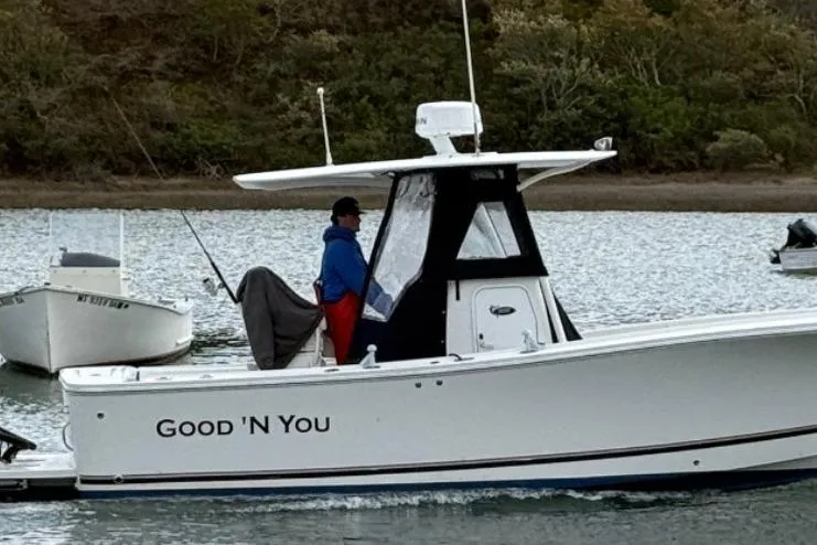 Slide: The Image of 2015 Regulator 25 boat named "Good 'N You" on calm water. - 1