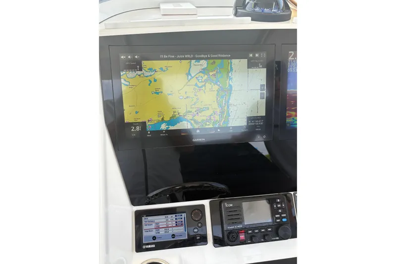 Slide: The Image of 2015 Regulator 25 boat dashboard with Garmin navigation display and Yamaha controls. - 8