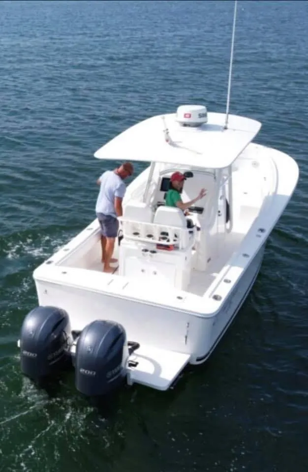 Slide: The Image of 2015 Regulator 25 on the water with twin outboard engines. - 18
