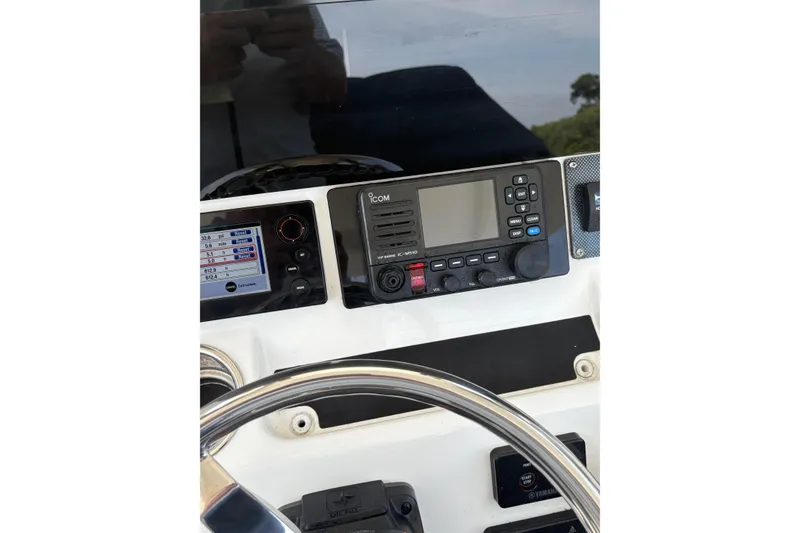 Slide: The Image of Control panel of a 2015 Regulator 25 boat with Icom radio and steering wheel. - 6