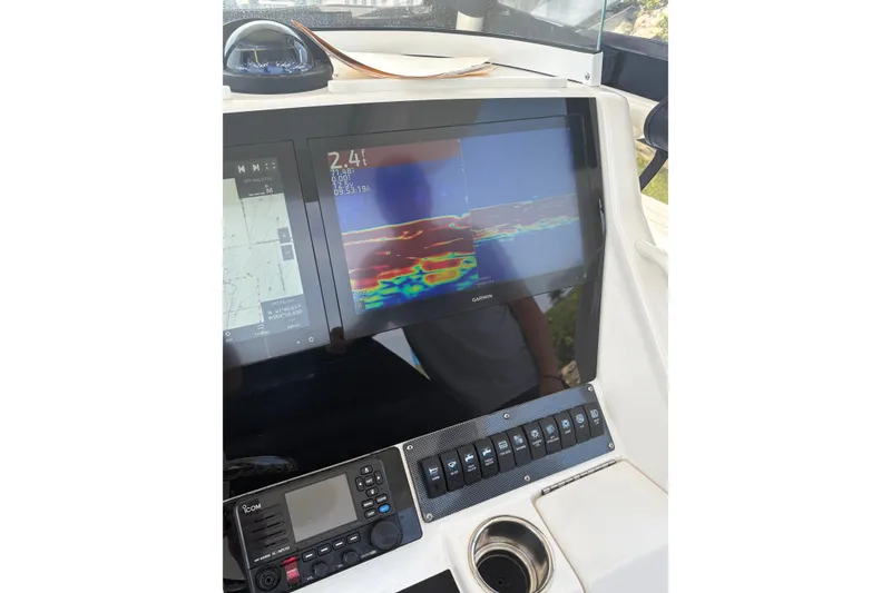 Slide: The Image of Dashboard of a 2015 Regulator 25 boat featuring Garmin navigation and control systems. - 7
