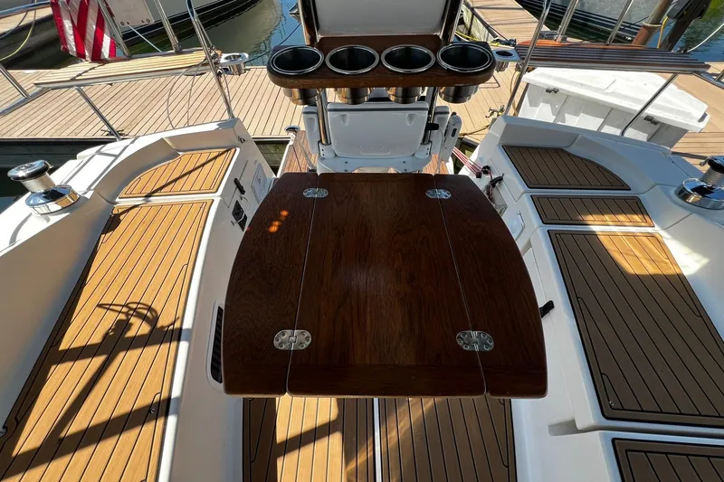 Slide: The Image of Cockpit of 2015 Hunter 37 sailboat with wooden table and cup holders. - 8