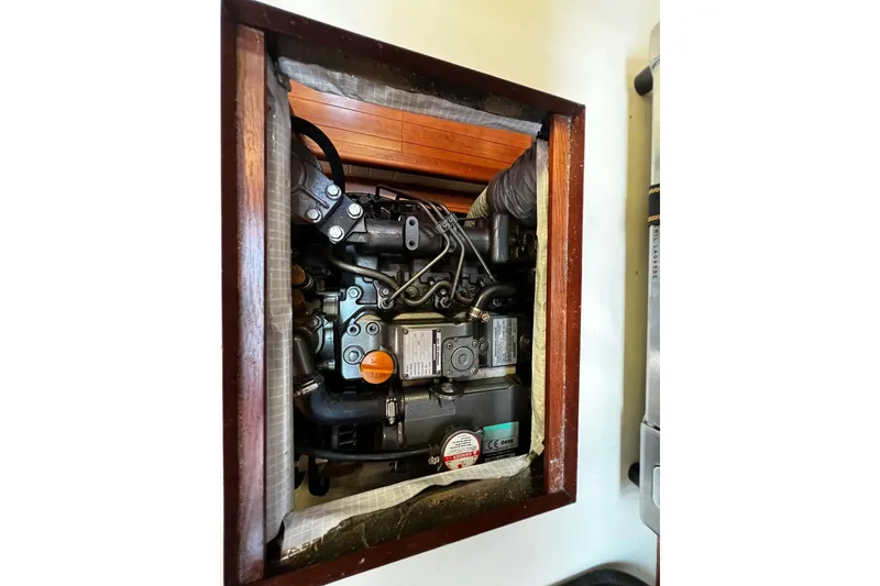 Slide: The Image of Engine compartment of a 2015 Hunter 37 sailboat, showcasing mechanical components. - 52