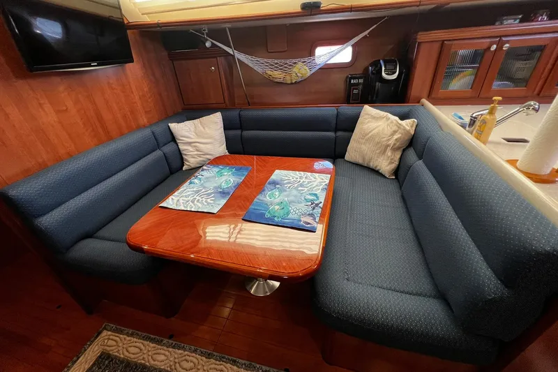 Slide: The Image of Luxurious interior of a 2015 Hunter 37 yacht with plush seating and elegant wood finishes. - 42
