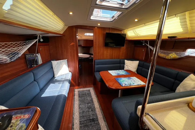 Slide: The Image of Interior of a 2015 Hunter 37 yacht with cozy seating and elegant wood finishes. - 56