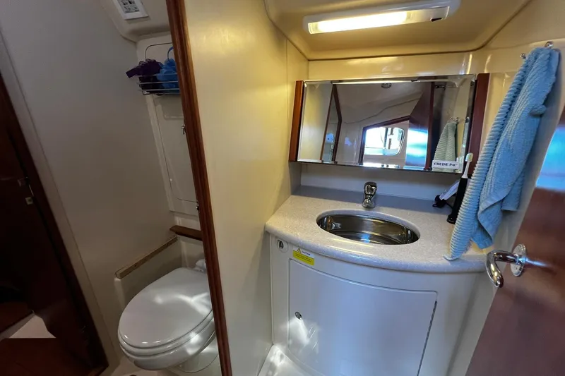 Slide: The Image of Compact bathroom in a 2015 Hunter 37 yacht, featuring a sink, mirror, and toilet. - 33