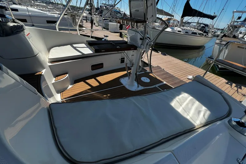 Slide: The Image of Cockpit of 2015 Hunter 37 sailboat with cushioned seating and steering wheel, docked at marina. - 16