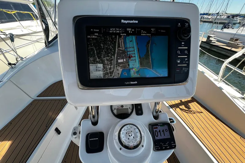 Slide: The Image of Cockpit of 2015 Hunter 37 sailboat with Raymarine navigation system and teak flooring. - 5