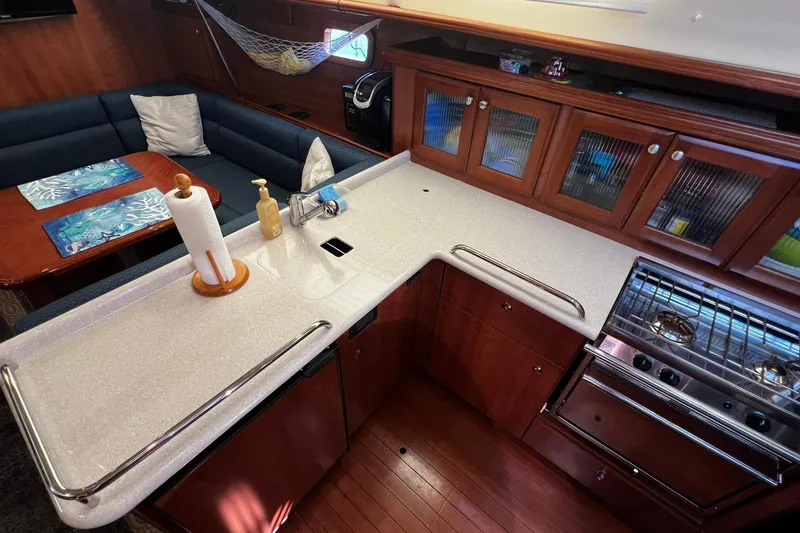 Slide: The Image of Luxurious 2015 Hunter 37 yacht interior with modern kitchen and cozy dining area. - 20