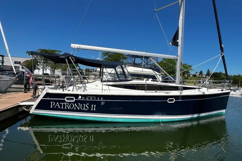 The Image of 2015 Hunter 37 sailboat "Patronus II" docked at marina under clear blue sky. - 0