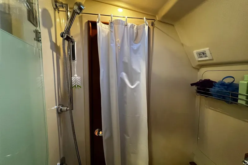 Slide: The Image of Shower area in a 2015 Hunter 37 yacht, featuring curtain and toiletries. - 36