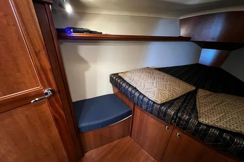 Slide: The Image of Cozy cabin interior of 2015 Hunter 37 sailboat with wooden finish and cushioned seating. - 47