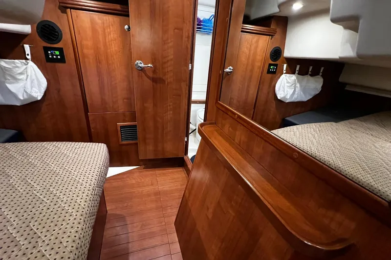 Slide: The Image of Interior of 2015 Hunter 37 sailboat with wooden finish and cozy sleeping area. - 30