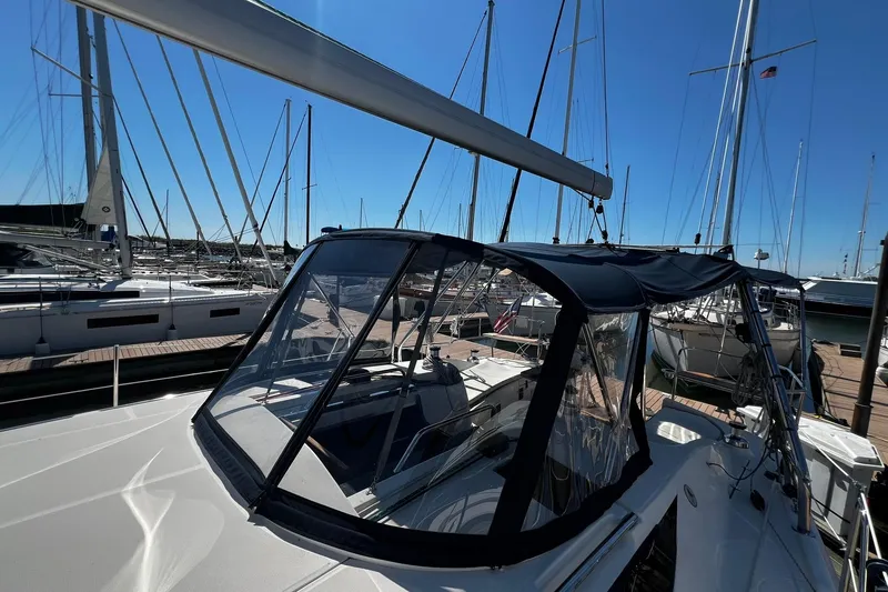 Slide: The Image of 2015 Hunter 37 sailboat docked at marina under clear blue sky. - 15