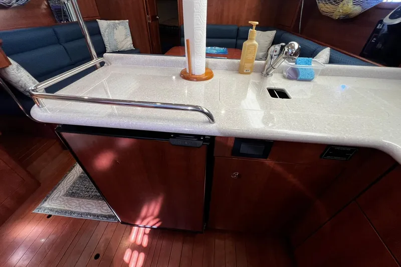 Slide: The Image of Modern galley kitchen in 2015 Hunter 37 yacht with sleek countertops and wooden cabinetry. - 26